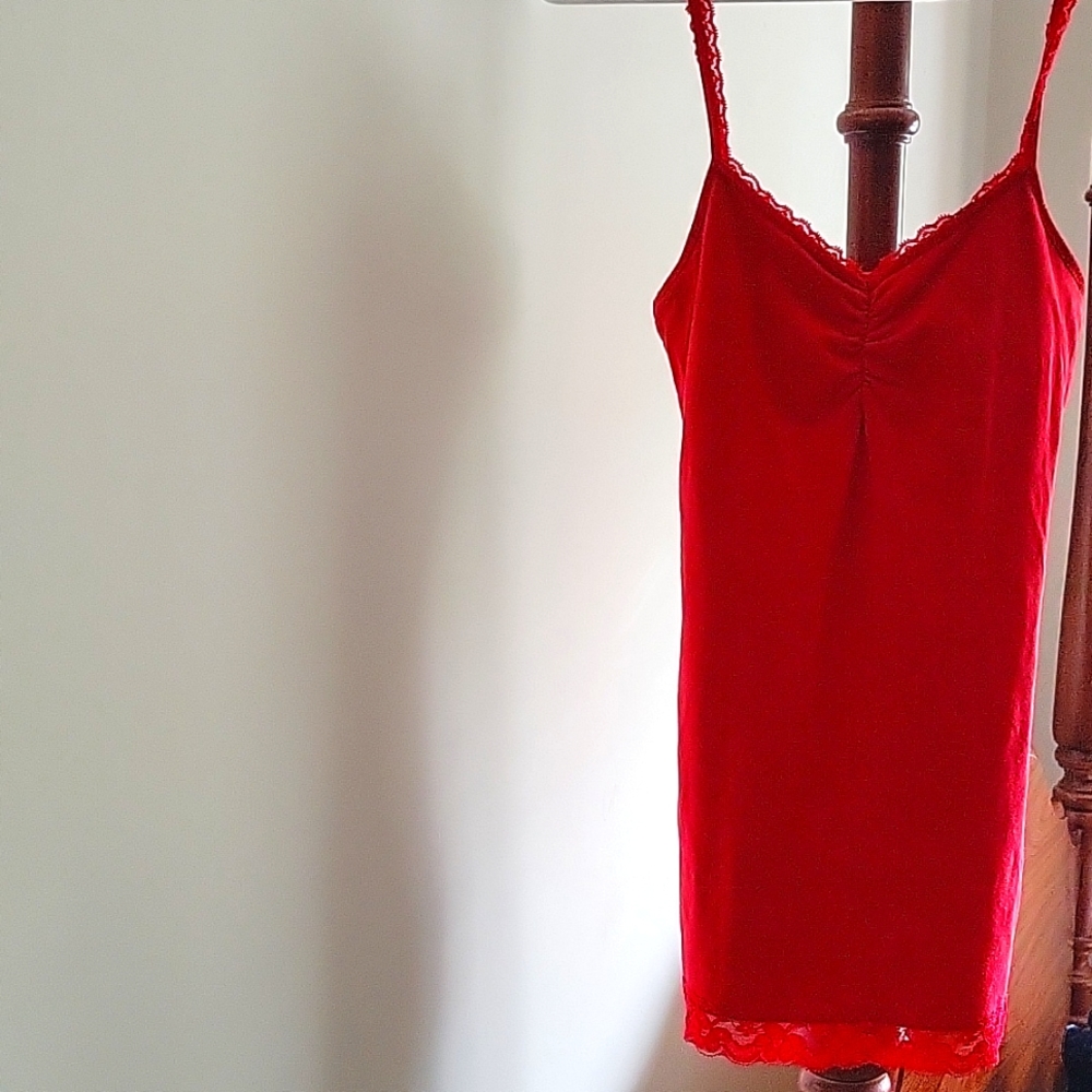 A red tank top with lace at the bottom